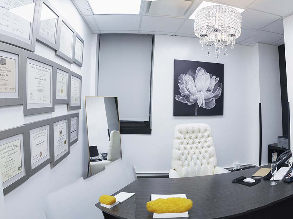 Consultation office at New York Breast Surgery Center with framed medical credentials