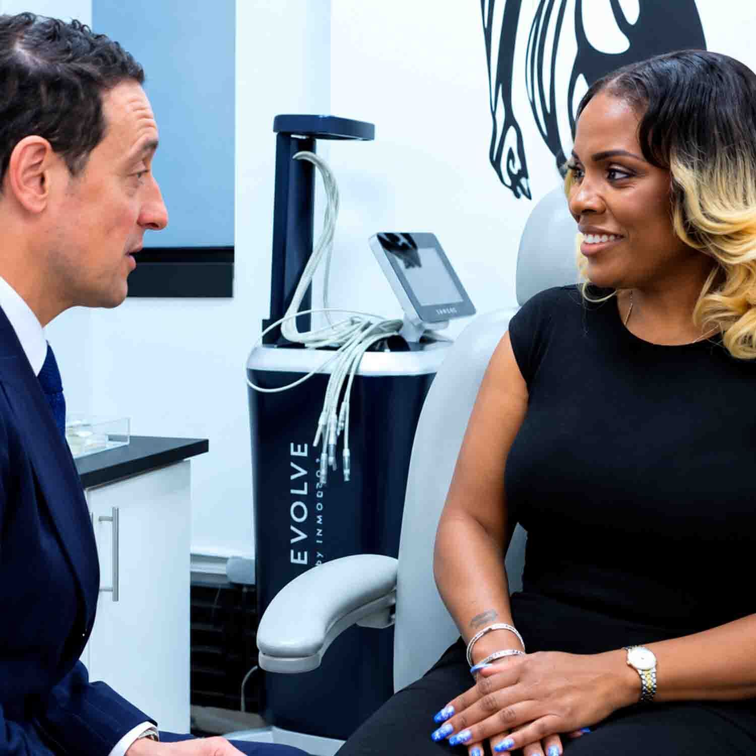 Dr. David Shokrian discussing breast revision surgery with a patient in NYC